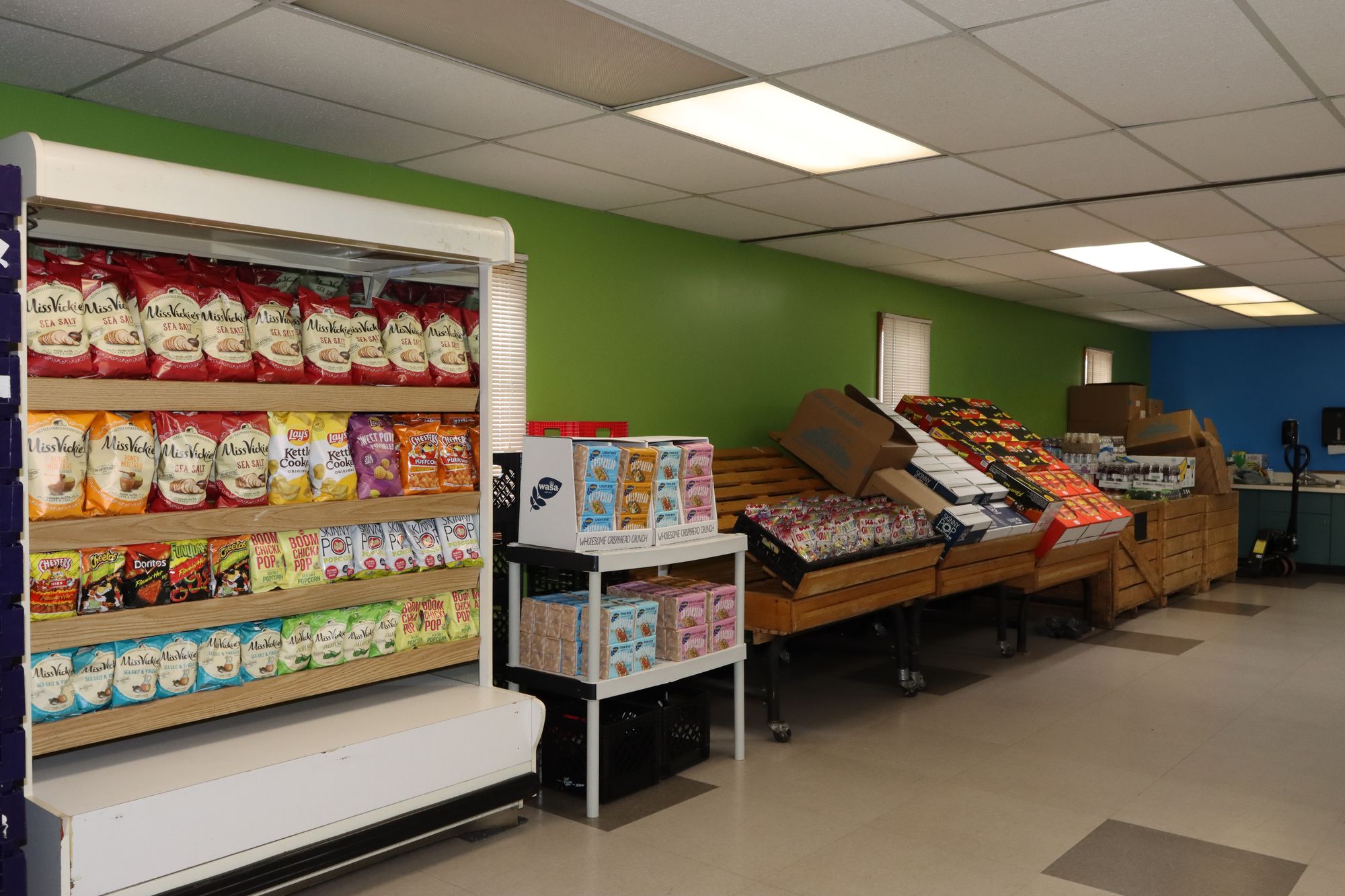 Here2Serve Outreach food pantry shelves stocked with groceries and snacks